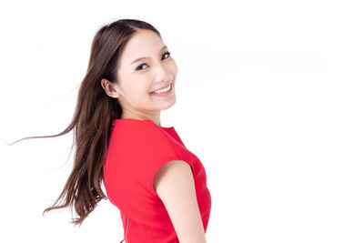 Portrait of a smiling young woman against white background