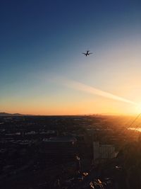 Aerial view of city against sky during sunset