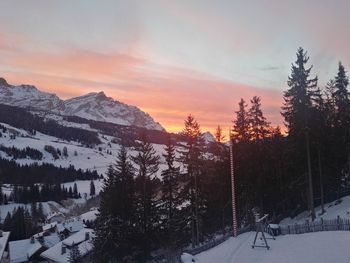 Scenic view of snow covered mountains against sky during sunset