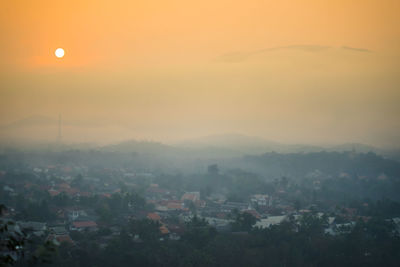 Aerial view of townscape against sky during sunset
