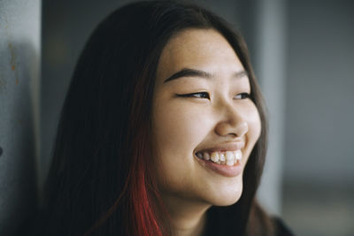 Smiling female teenager looking away