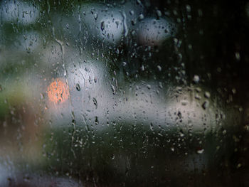 Full frame shot of wet glass window during rainy season