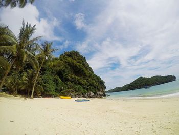 Scenic view of beach against blue sky