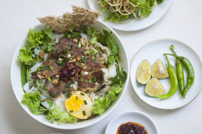 Vietnamese noodle - my quang, vietnamese traditional cuisine, noodles in bowl on the table 