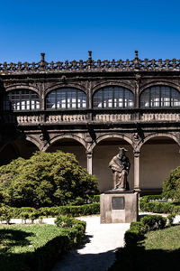 Statue of historic building against blue sky