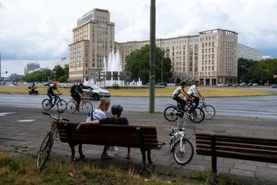 Bicycles on street against buildings in city