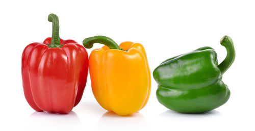 Close-up of bell peppers against white background