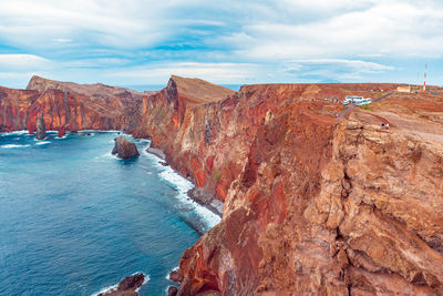 Scenic view of sea and mountains against sky