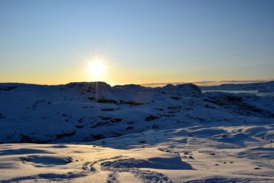 Scenic view of snow mountains against sky during sunset