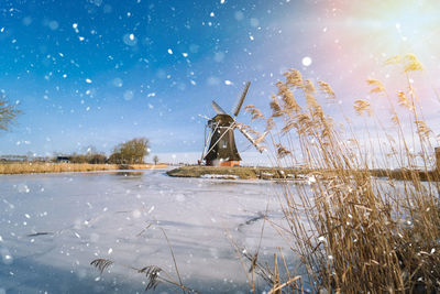 Snow on field against sky during winter