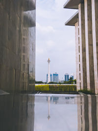 Buildings in city against cloudy sky