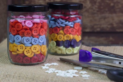 Close-up of multi colored glass jar on table
