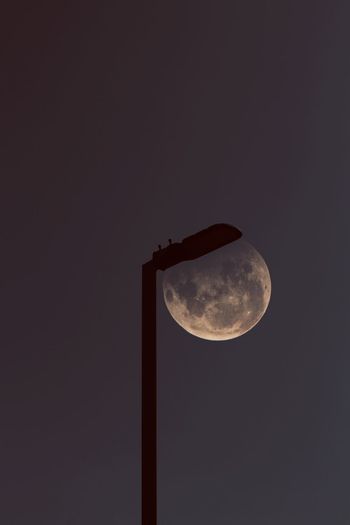 Low angle view of moon against clear sky at night