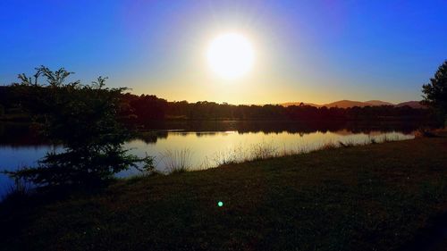 Scenic view of calm lake at sunset