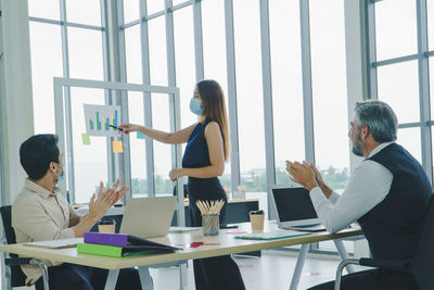 Businesswoman giving presentation in office