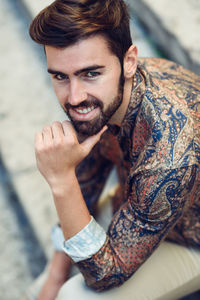 Portrait of young man sitting on steps