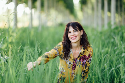 Portrait of smiling young woman on field