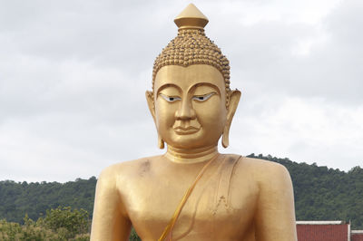 Low angle view of statue against cloudy sky