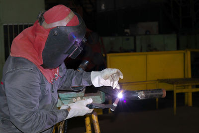 Side view of manual worker working in factory