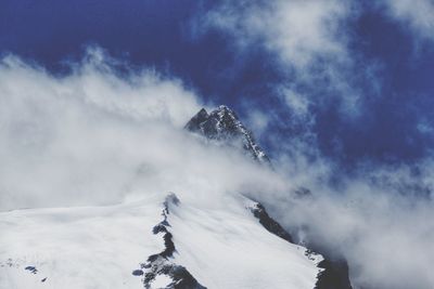 Low angle view of snowcapped mountain against sky