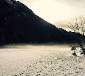 Scenic view of snow covered mountains against sky