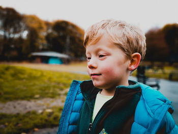 Portrait of boy looking away outdoors