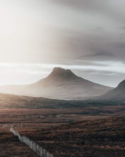 Scenic view of landscape against cloudy sky