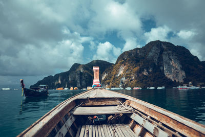 Scenic view of sea and mountains seen from boat against sky