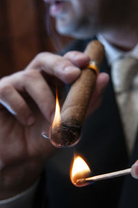 Close-up of hand holding cigarette