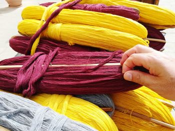 Close-up of hand holding strings at market