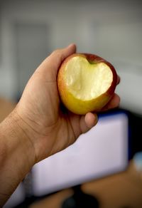 Close-up of hand holding apple