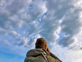 Low angle view of woman against sky