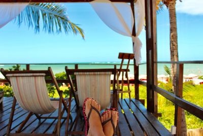 Low section of woman relaxing while sitting outdoors