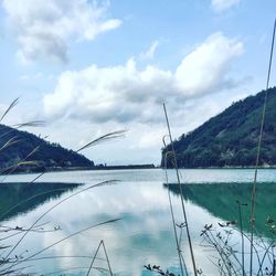 Scenic view of lake against cloudy sky