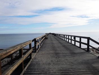 Pier over sea against sky