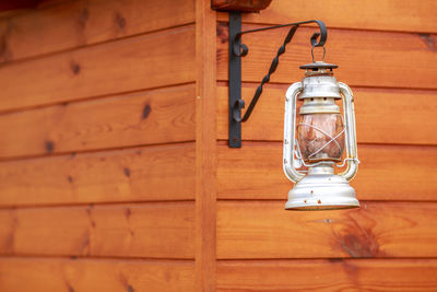 Close-up of lantern hanging on metal