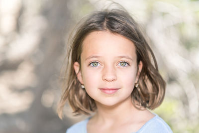 Close-up portrait of girl standing outdoors