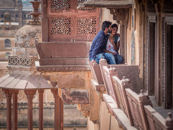 Young couple sitting outdoors