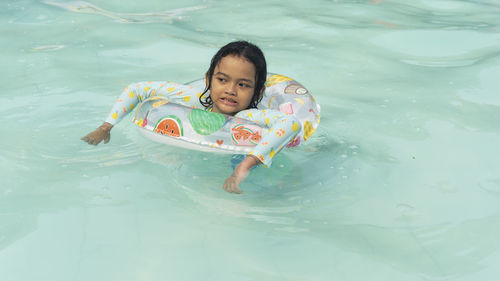 Portraits of asian girl wearing a swimsuit. swimming in the pool