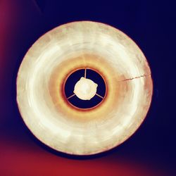 Low angle view of illuminated light bulb against sky