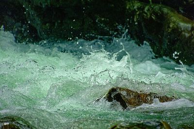 View of water flowing through rocks