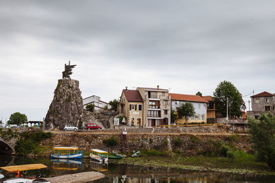 View of buildings against cloudy sky