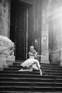 Full length of woman dancing on building