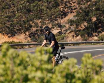 Side view of man standing on road