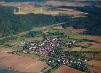 High angle view of agricultural field and buildings in city