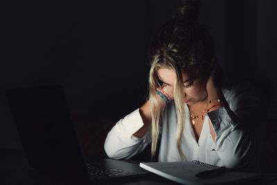 Young woman using laptop at table