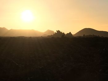 Scenic view of mountains against sky at sunset