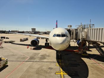 Airplane on airport runway against clear sky