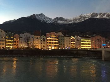 Reflection of buildings in city at waterfront