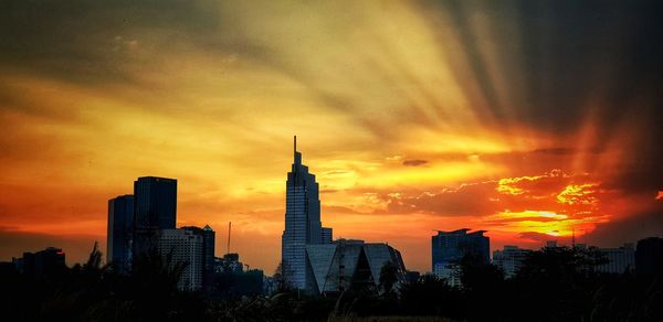 Buildings in city during sunset